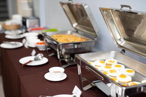 a buffet with eggs and other food on a table at Tara Park Resotel in Ban Talat Rangsit