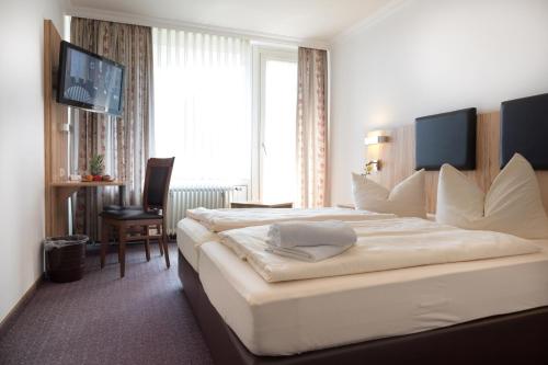 Postel nebo postele na pokoji v ubytování Hotel Promenade