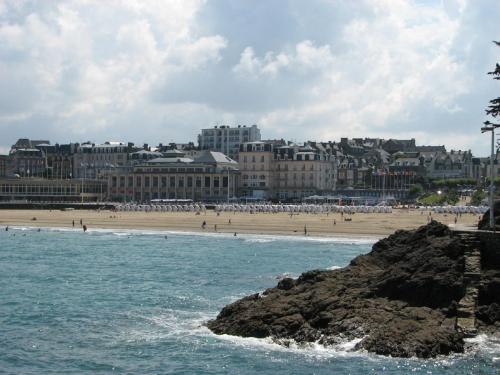 a beach with a group of people on the beach at Studio Winston in Dinard