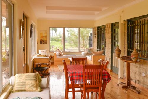 a living room with a table and chairs at Bessotted Farmstay in Nanyuki