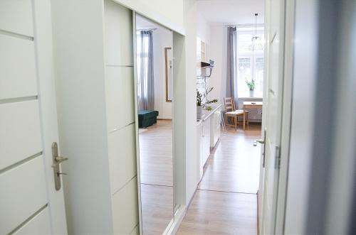 a hallway leading to a kitchen with a mirror at Apartament Mickiewicza in Wadowice