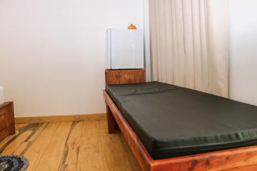 a room with a bed with a refrigerator in it at ANB Surf View in Tangalle