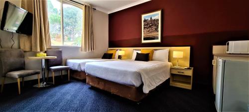 En eller flere senge i et værelse på Brunswick Tower Hotel