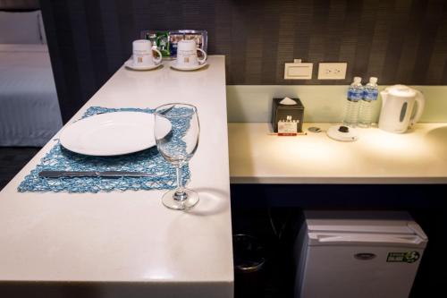 a kitchen counter with a plate and a wine glass at 台北碧瑤飯店 Hotel B in Taipei