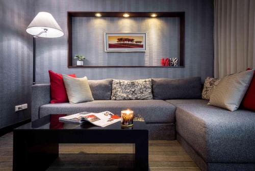 a living room with a couch and a table at 台北碧瑤飯店 Hotel B in Taipei