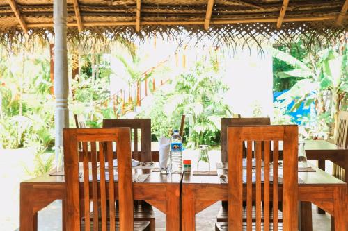 a table with two chairs and a table with a bottle of water at ANB Surf View in Tangalle
