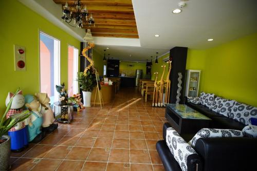 a living room with green walls and a tile floor at Wonderful Kenting Hostel in Eluan