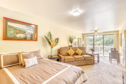 a bedroom with a bed and a couch and a window at Hale Moi 102B in Princeville