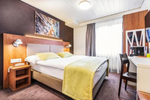 Postel nebo postele na pokoji v ubytování Campanile Martigny