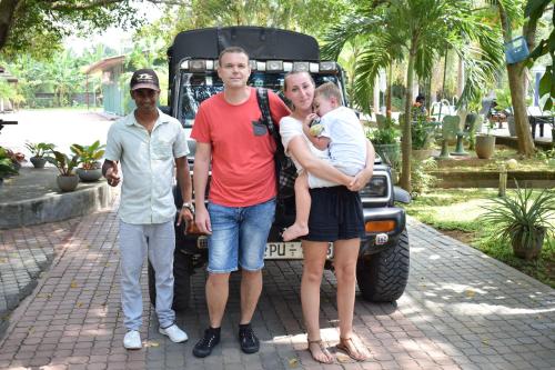 a group of three people standing in front of a truck at Tishan Holiday Resort in Polonnaruwa