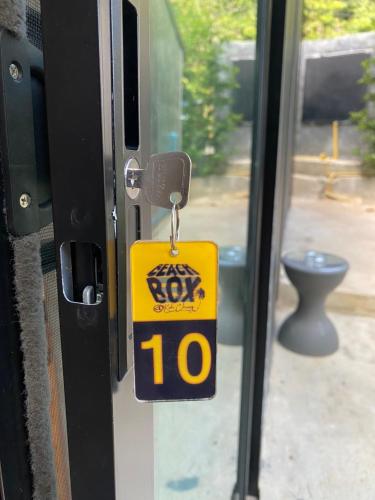 a door with a key tag on it on a door at BeachBox@Koh Сhang in Ko Chang