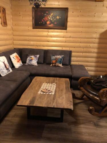 a living room with a couch and a coffee table at Chatka Katka in Liptovský Mikuláš