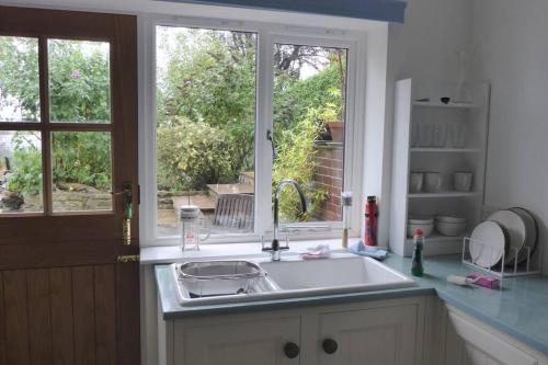 a kitchen with a sink and a window at Halcyon in Harrogate