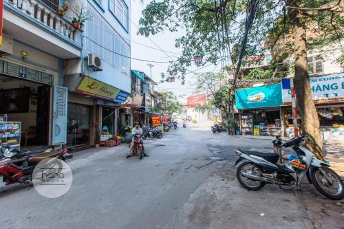 a group of motorcycles parked on a city street at Thien Phu Garden Hotel in Hanoi