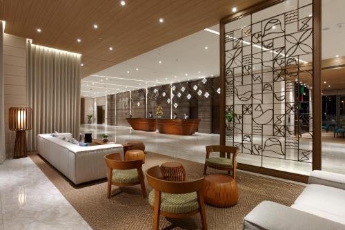 a lobby with a couch and a table and chairs at Discovery Hotel in Magong