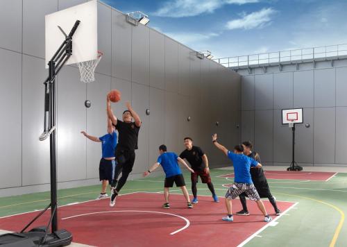 a group of men playing basketball on a basketball court at Discovery Hotel in Magong