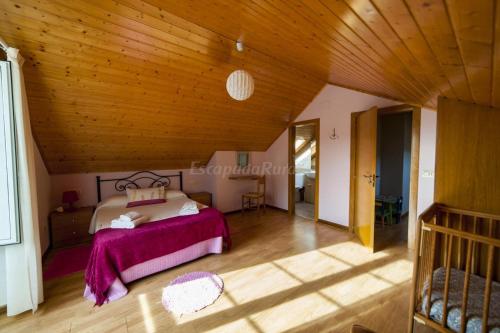 1 dormitorio con cama y techo de madera en Casa Do Centeal en Arrueiro
