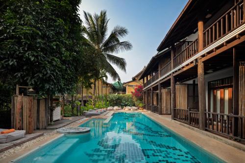 a swimming pool in the middle of a building at Maison Dalabua in Luang Prabang