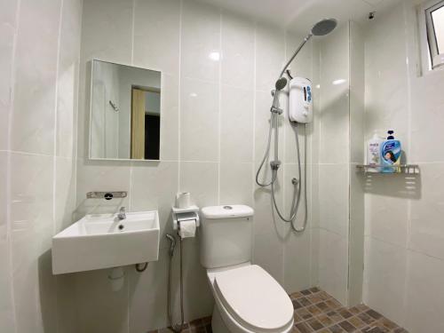 a bathroom with a shower and a toilet and a sink at Langkawi Simfoni Beliza Apartment with Sky Pool by Zervin in Kuah