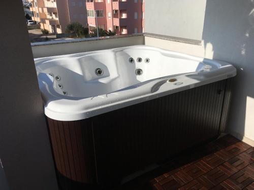 a large bath tub in a bathroom with a window at Apartment Electro with Jacuzzi in Novalja