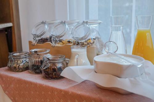 a table with jars and utensils on a table at Alpenpension Haslinger in Bad Gastein