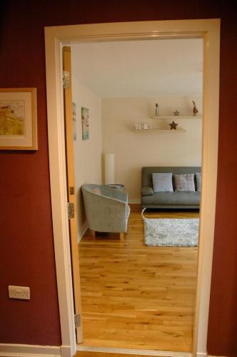 a view of a living room with a couch at The Socair - Bright Contemporary Merchant City Flat in Central Location in Glasgow