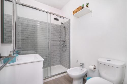 a bathroom with a shower and a toilet and a sink at APARTAMENTO COR DO MAR - Sunny, Clean and spacious apartment with sea view, in Alvor - very close walking distance to the beach and Alvor Village in Alvor