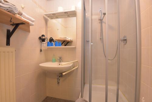 a bathroom with a shower and a sink at Hotel Wolke in Meiningen