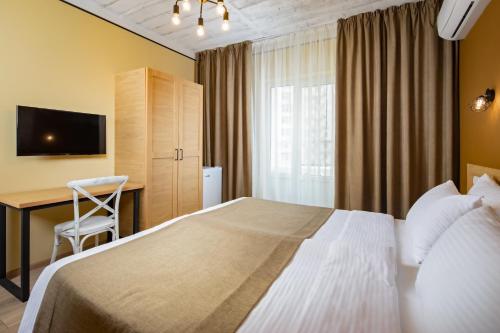 Ένα ή περισσότερα κρεβάτια σε δωμάτιο στο Yuzhnaya Dacha