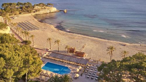 an aerial view of a beach with palm trees and a resort at Secrets Mallorca Villamil Resort & Spa - Adults Only (+18) in Paguera