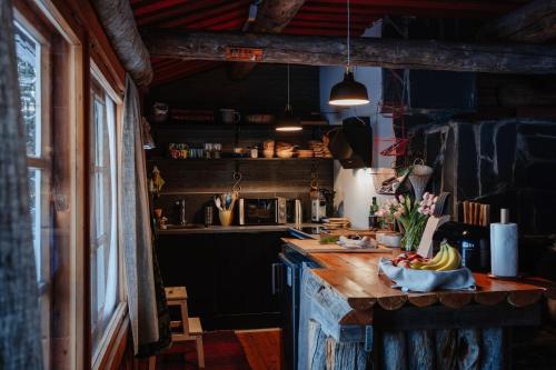 a kitchen with a counter with a bowl of fruit on it at Ollero Eco Lodge (including a glass igloo) in Rovaniemi