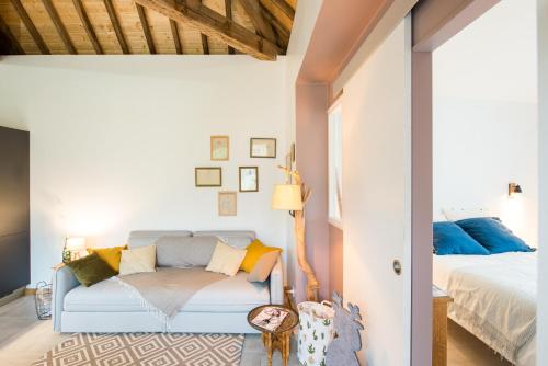 a bedroom with a blue couch and a bed at Château de la Malmaison in Champillon