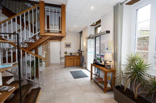 a hallway with a staircase in a building at Contact Hôtel - Hôtel Le Lion d'Or Lamballe in Lamballe