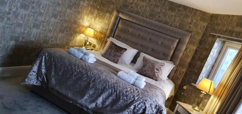 a bedroom with a large bed with pillows at The Lord Street Hotel; BW Signature Collection in Southport