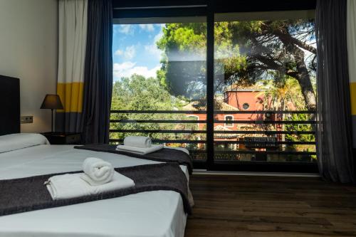 a hotel room with two beds and a large window at Royal Tennis Club in Marbella