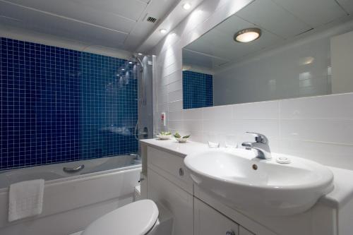 a bathroom with a sink and a toilet and a mirror at 9 Hertford Street - 4 Stars VisitEngland in London