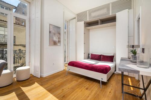 a bedroom with a bed and a desk at WHome | Alcântara Smart Studio in Lisbon