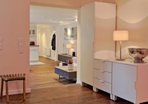 a living room with a dresser and a dining room at Thiel Apartments in Krefeld