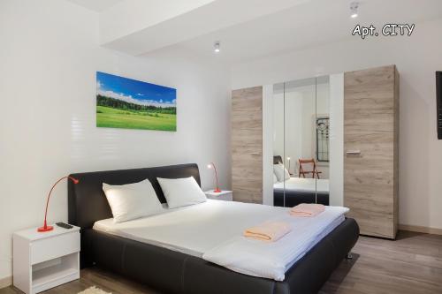 a bedroom with a large bed in a room at City Holliday Lux in Belgrade