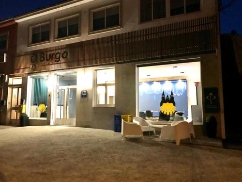 a store front of a building at night at Albergue O Burgo in O Pedrouzo