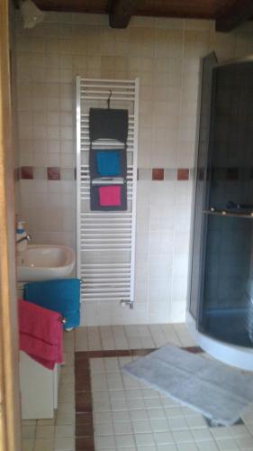 a bathroom with a shower and a sink and a tub at Apartman Ema in Sloup