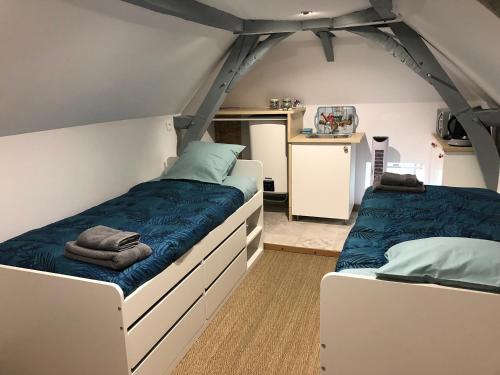 a bedroom with two beds in a tent at Manoir de la Grand'Cour in Soulgé-sur-ouette