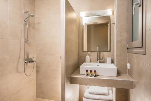 a bathroom with a sink and a shower at Caravel Apartments Stalis in Stalida