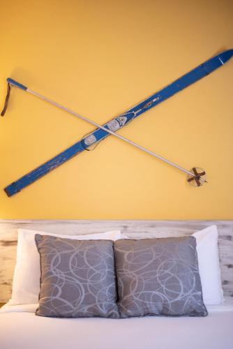 a hockey stick hanging on a wall above a bed at Mountain Inn at Lutsen in Lutsen