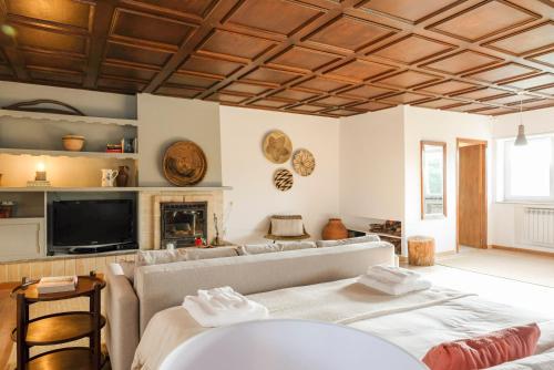 a living room with a couch and a tv at Lisbon Country Villa in Oeiras