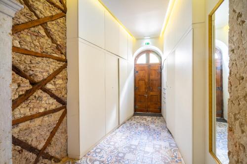 a hallway with a door and a tile floor at WHome | Alcântara Premium Studio in Lisbon