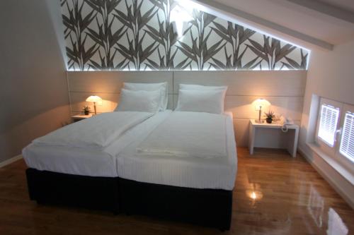 a bedroom with a large bed with a large window at Hotel Villa Milas in Mostar