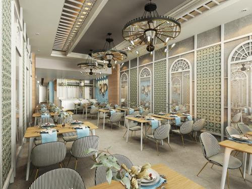 a restaurant with tables and chairs and a chandelier at PAMPHYLIA HOTEL in Valencia