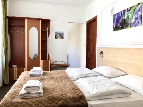 a bedroom with a large bed with two towels on it at АВІА in Uzhhorod