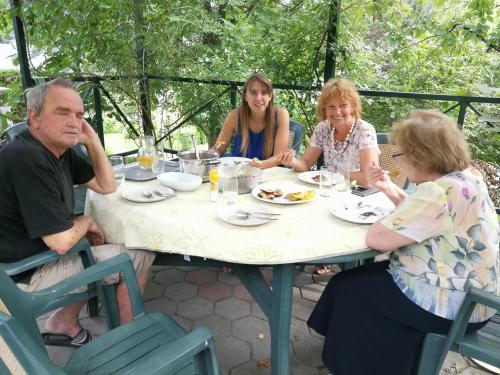 a group of people sitting around a table at Green Oasis in Sladki Vrh